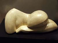Sculpture of a resting figure carved in limestone entitled 'Asleep-series 2'